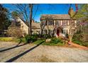 Inviting two-story home with manicured lawn, red door, mature landscaping, and charming curb appeal at 213 Huntington Dr, Chapel Hill, NC 27514