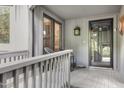 Covered front porch with seating area and a view of the entry door to the home at 227 Windlestraw, Pittsboro, NC 27312
