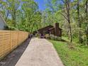 Long driveway leading to a cozy home surrounded by trees and a fenced-in yard at 2419 George Anderson Dr, Hillsborough, NC 27278