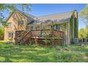 Exterior shot of a wooden deck and the back of the house with brick and shingle siding at 2510 Poplar Creek Rd, Henderson, NC 27537