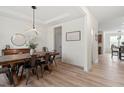 Modern dining room features a modern light fixture and wood-style floors, offering ample space for entertaining at 275 Sunrise Ridge Dr, Willow Springs, NC 27592