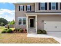 Close-up view of the home's front entrance, showing the front yard landscaping at 275 Sunrise Ridge Dr, Willow Springs, NC 27592