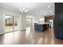 Open floor plan featuring an island kitchen, dining area and access to the back yard at 2901 Murray Ridge Trl, Apex, NC 27502