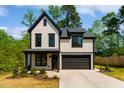 Two-story home featuring a modern farmhouse design with black trim and a two-car garage at 3221 Skycrest Dr, Raleigh, NC 27604