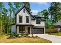 Two-story home featuring a modern farmhouse design with black trim and a two-car garage at 3221 Skycrest Dr, Raleigh, NC 27604