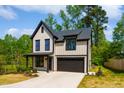 Two-story home featuring a modern farmhouse design with black trim and a two-car garage at 3221 Skycrest Dr, Raleigh, NC 27604