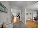Spacious hallway showcasing hardwood floors and seamless flow into the living room, promoting an airy atmosphere at 3646 Watkins Farm Rd, Hillsborough, NC 27278