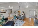 Bright living room with hardwood floors, vaulted ceilings, and an open staircase creates an airy and welcoming atmosphere at 3646 Watkins Farm Rd, Hillsborough, NC 27278