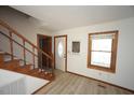 Bright entryway featuring wood-look floors, staircase, and decorative front door at 3813 W West Lake Rd, Apex, NC 27539