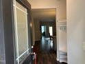Inviting entryway with dark wood floors, storage, and clear sightlines to the dining area at 48 Cullen Ct, Clayton, NC 27520