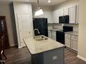 Modern kitchen with granite countertops, stainless steel appliances, and ample cabinet space at 48 Cullen Ct, Clayton, NC 27520