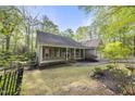 Beautiful home with a covered porch, surrounded by lush landscaping and mature trees at 50 Beech Trl, Garner, NC 27529