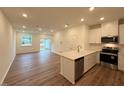 Open-concept living room with luxury vinyl flooring and abundant natural light at 512 Eastwood St, Durham, NC 27704