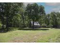 Peaceful home nestled among mature trees, offering plenty of outdoor space for recreation at 5200 Lorbacher Rd, Apex, NC 27539