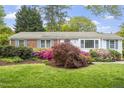 Lovely home featuring a well-manicured lawn and colorful landscaping, enhancing its curb appeal at 611 Beaver Dam Rd, Raleigh, NC 27607