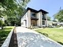 Stunning two-story home with a mix of stone and siding, complemented by a long, spacious concrete driveway at 622 Glascock St, Raleigh, NC 27604