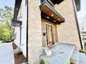 Inviting front entrance with stone accents and a wood-covered porch and tiled porch at 622 Glascock St, Raleigh, NC 27604