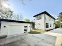 Detached two-car garage with white door and modern design, next to the home at 622 Glascock St, Raleigh, NC 27604