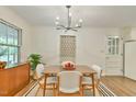Dining room featuring wood floors, modern chandelier, and mid century modern cabinet at 775 Old Graham Rd, Pittsboro, NC 27312