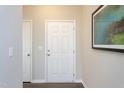 Inviting entryway with a classic white door, neutral walls, and stylish decor at 79 Fern Ridge Dr, Cameron, NC 28326