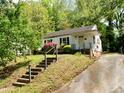 Exterior home view with beautiful landscaping including azaleas and mature trees at 810 Nancy St, Durham, NC 27701