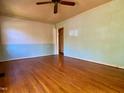 Unfurnished living room featuring hardwood floors, light colored paint and ceiling fan at 810 Nancy St, Durham, NC 27701
