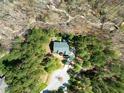 An aerial view of a home with driveway and wooded property at 83 Calabria Ct, Clayton, NC 27527