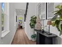 Bright entryway with wood floors, black stair railing and decorative table with decor at 834 Day Ave, Burlington, NC 27217