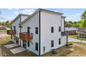 Rear exterior view of the modern two-story house featuring wood decks on the second story at 834 Day Ave, Burlington, NC 27217