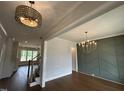View of a dining room showing the ceiling and wall moldings, hardwood flooring, and decorative lighting at 921 Lily Claire Ln, Fuquay Varina, NC 27526