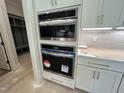 Modern kitchen appliances including a built-in microwave and oven at 921 Lily Claire Ln, Fuquay Varina, NC 27526