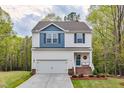 Inviting home with a neat lawn, a cozy front porch, and a convenient attached garage at 10 Shearin Ln, Youngsville, NC 27596