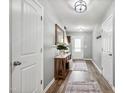 Neutral hallway featuring hardwood floors, and decorative mirrors, creating an inviting entry at 10 Shearin Ln, Youngsville, NC 27596