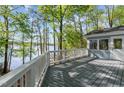 Spacious deck with scenic lake views, surrounded by lush greenery at 104 Chuckwagon Dr, Louisburg, NC 27549