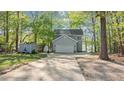 Charming two-story home with a large driveway and a storage shed at 104 Chuckwagon Dr, Louisburg, NC 27549