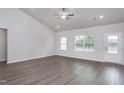 Bright living room features vaulted ceilings, wood-look floors, and ample natural light from the large windows at 11470 International Dr, Middlesex, NC 27557