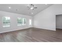 Bright living room features vaulted ceilings, wood-look floors, and ample natural light from the large windows at 11470 International Dr, Middlesex, NC 27557