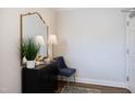 Elegant entryway with a decorative mirror, lamp, and stylish furnishings at 1200 Gathering Park Cir # 302, Cary, NC 27519