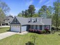 Beautiful blue home with a two-car garage, dormer windows, and well-maintained landscaping at 129 Camille Cir, Youngsville, NC 27596