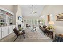 Spacious living room featuring a fireplace, built-in shelving, and large windows with bright natural light at 129 Camille Cir, Youngsville, NC 27596