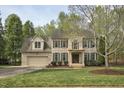 Charming two-story brick home featuring a front yard, manicured landscaping and a welcoming front entrance at 1335 Saint Andrews Dr, Mebane, NC 27302
