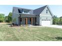 Charming home featuring a two-car garage and well-manicured lawn at 1394 Delma Grimes Rd, Coats, NC 27521