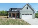 Charming home featuring a two-car garage and well-manicured lawn at 1394 Delma Grimes Rd, Coats, NC 27521