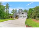 Charming two-story farmhouse with mature trees, landscaped lawn and a three-car garage at 1506 Gormly Cir, Sanford, NC 27330