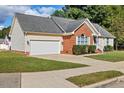 Well-maintained home with a two-car garage, brick facade, and a welcoming driveway at 1601 Entheos Ln, Raleigh, NC 27610