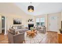 Staged living room featuring a fireplace, ample seating, and bright natural light at 1601 Entheos Ln, Raleigh, NC 27610