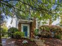 Charming brick home featuring a blue front door adorned with a wreath and surrounded by lush landscaping at 1640 Legendary Ln, Morrisville, NC 27560