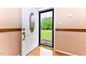 A bright, white front door with a decorative glass window welcomes you into this charming home at 1744 Prince Edward Dr, Elon, NC 27244