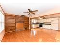 Open-concept living space with brick fireplace, built-in shelves and seamless flow into the kitchen at 1744 Prince Edward Dr, Elon, NC 27244