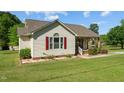 Charming single-story home with tidy landscaping, red shutters, and inviting front porch at 20 Sanders Rd, Benson, NC 27504